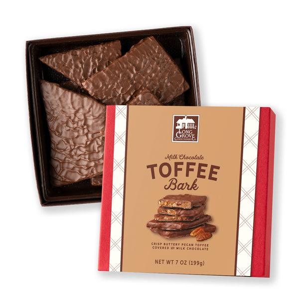 Box of milk chocolate toffee bark with packaging on a white background
