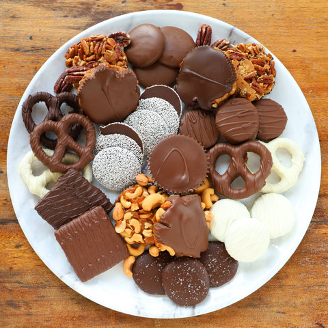 Buttery Caramel, crunchy milk-white-dark chocolate covered pretzels, chocolate covered cookies, Giant Peanut Butter Cup, and 3 Giant Myrtles with salty roasted pecan or cashews